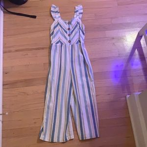 Jumpsuit with ruffles and buttons down the middle.